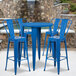 A Flash Furniture blue metal bar height table with blue metal chairs.