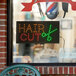A rectangular LED sign that says "Hair Cut" in white letters.