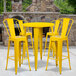 A Flash Furniture yellow metal table with yellow stools.
