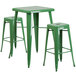 A green metal table with 2 square seat backless stools.