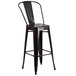 A black metal bar stool with a round seat.