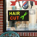 A rectangular LED sign that says "Hair Cut" in red letters on a black background.