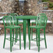 A Flash Furniture green metal bar table with green chairs.