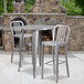 A Flash Furniture bar height table with metal chairs and a stone fireplace.