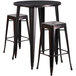 A Flash Furniture round bar height table in black with three square seat stools.