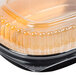 A Durable Packaging Black and Gold aluminum foil take-out pan with a clear plastic lid.