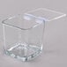 A clear square glass container with a hinged plastic lid.