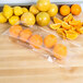 Sliced oranges and lemons in LK Packaging plastic food bags on a table.