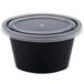 A Newspring black oval souffle container with a clear lid.