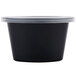 A black Newspring oval souffle container with a clear lid.