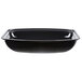 A black rectangular Cambro serving bowl with ribbed sides.