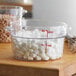 A close up of a Cambro measuring cup filled with white marshmallows.