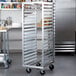 A Metro aluminum roll-in refrigerator rack in a professional kitchen.