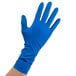 A hand wearing a blue High Risk Latex Exam Glove.