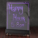 A purple Aarco lighted write-on menu board on a bar counter with purple writing that says "Happy Hour"