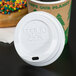 A white Eco-Products recycled content plastic lid on a coffee cup.