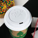 A white Eco-Products paper cup lid on a coffee cup.