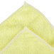 A yellow Unger SmartColor Microfiber cleaning cloth with white edges.