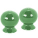 Two green Fiesta salt and pepper shakers with white squares on a white background.