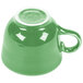 A green Fiesta china tea cup with a handle.