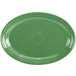 A green oval platter with a white rim.