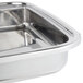 A stainless steel rectangular food pan from Vollrath for a square chafer on a counter.