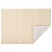 A white square paper placemat with a scalloped ivory edge.