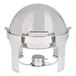 A Vollrath stainless steel round chafer with a round lid with brass trim.