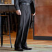 A man wearing Henry Segal black dress pants and a black shirt.