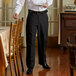 A man wearing Henry Segal black dress pants standing in a fine dining restaurant.
