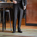 A man wearing Henry Segal black dress pants standing in a bar.