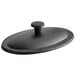 A black cast iron lid with an oval shape.
