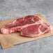 Two Warrington Farm Meats frozen porterhouse steaks on a brown paper