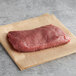 A Warrington Farm Meats flat iron steak on a piece of paper.