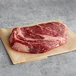 A piece of raw Warrington Farm Meats Delmonico steak on a paper.