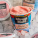 A container of Minute Maid Soft Frozen Strawberry Lemonade on ice.