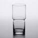 A close-up of a clear Libbey stackable beverage glass with a half empty rim.