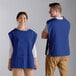 A man and woman wearing Choice Royal Blue poly-cotton cobbler aprons.
