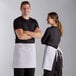 A man and woman wearing white Choice waist aprons.