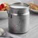 A Vollrath stainless steel mini milk can.
