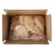 A box filled with plastic bags of Brakebush Farm Pantry boneless skinless chicken fillets.