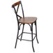 A BFM Seating Henry metal counter height stool with a wooden back and seat.