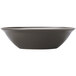 A white porcelain bowl with a matte olive interior and a dark brown rim.