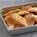 A tray of fried Brakebush Crispy-Lishus chicken strips.
