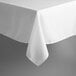 A white rectangular table cover with a hemmed edge on a table.
