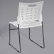 A Flash Furniture white plastic chair with black sled legs and air-vent back.
