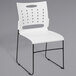A white Flash Furniture stack chair with black legs.
