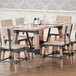 A Lancaster Table & Seating wooden trestle table base for a table with wine glasses and chairs.