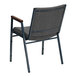 A gray fabric Flash Furniture stack chair with metal legs and wooden armrests.