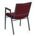A red Flash Furniture Hercules stack chair with metal legs and arms.